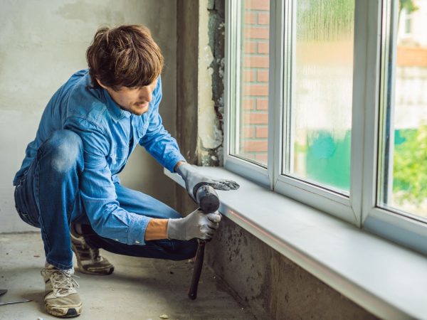 a man repairing window