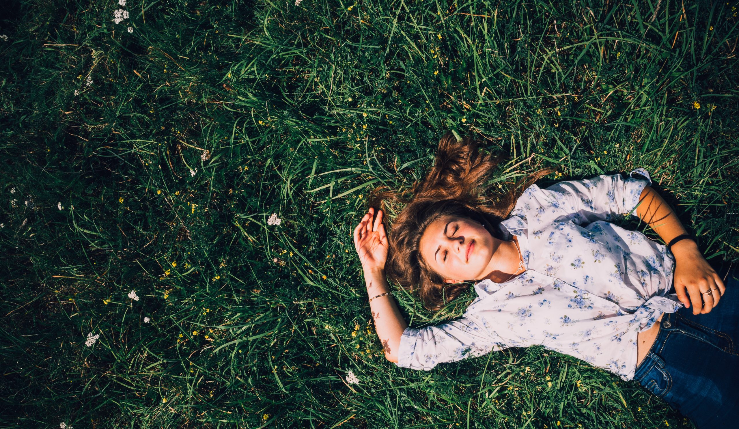 a girl laying on the grass