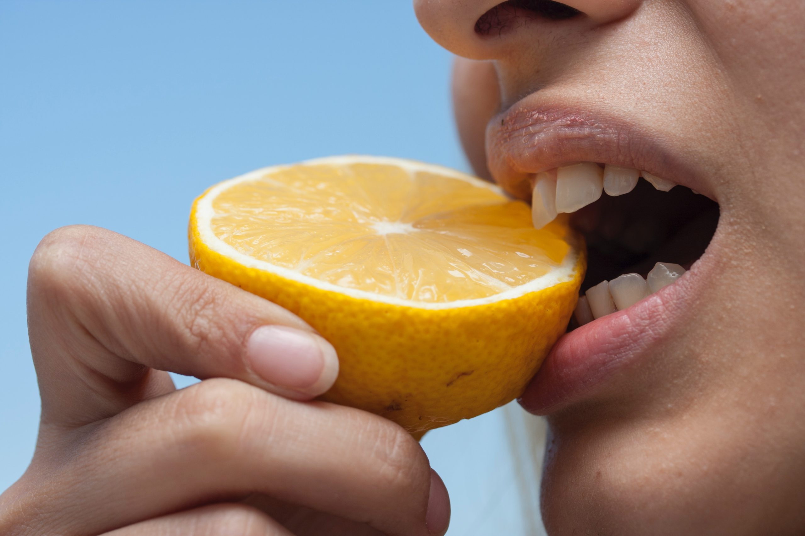 person chewing lemon