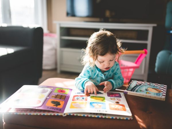 a toddler reading books