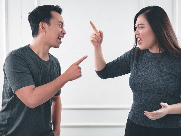 Finger pointing by husband wife at each other during argument