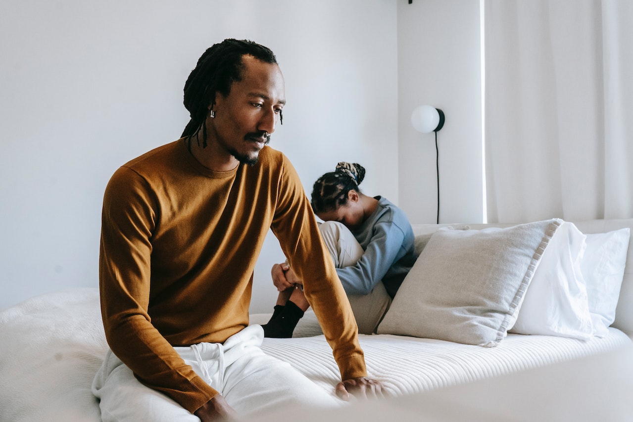 Black couple having conflict on bed due to their boring lifestyle 